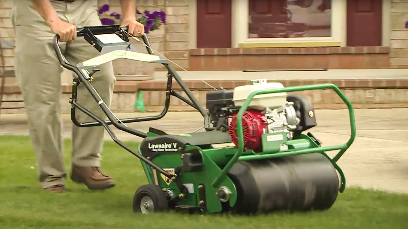 man operating a Ryan Lawnaire V Aerator with Easy Steer Technology