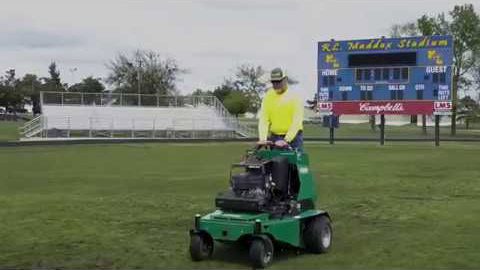 man operating a Lawnaire ZTS stand-on aerator